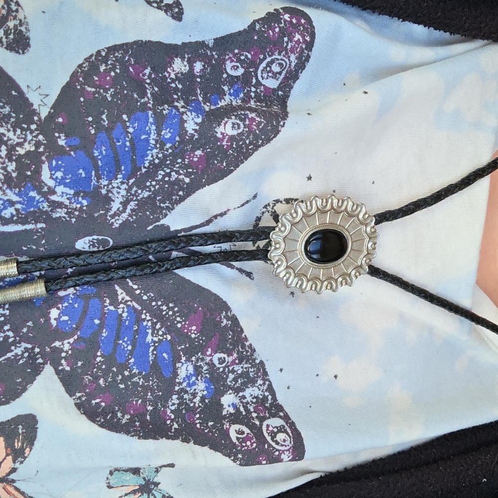 vintage-style Western bolo tie featuring a silver-toned sun pattern